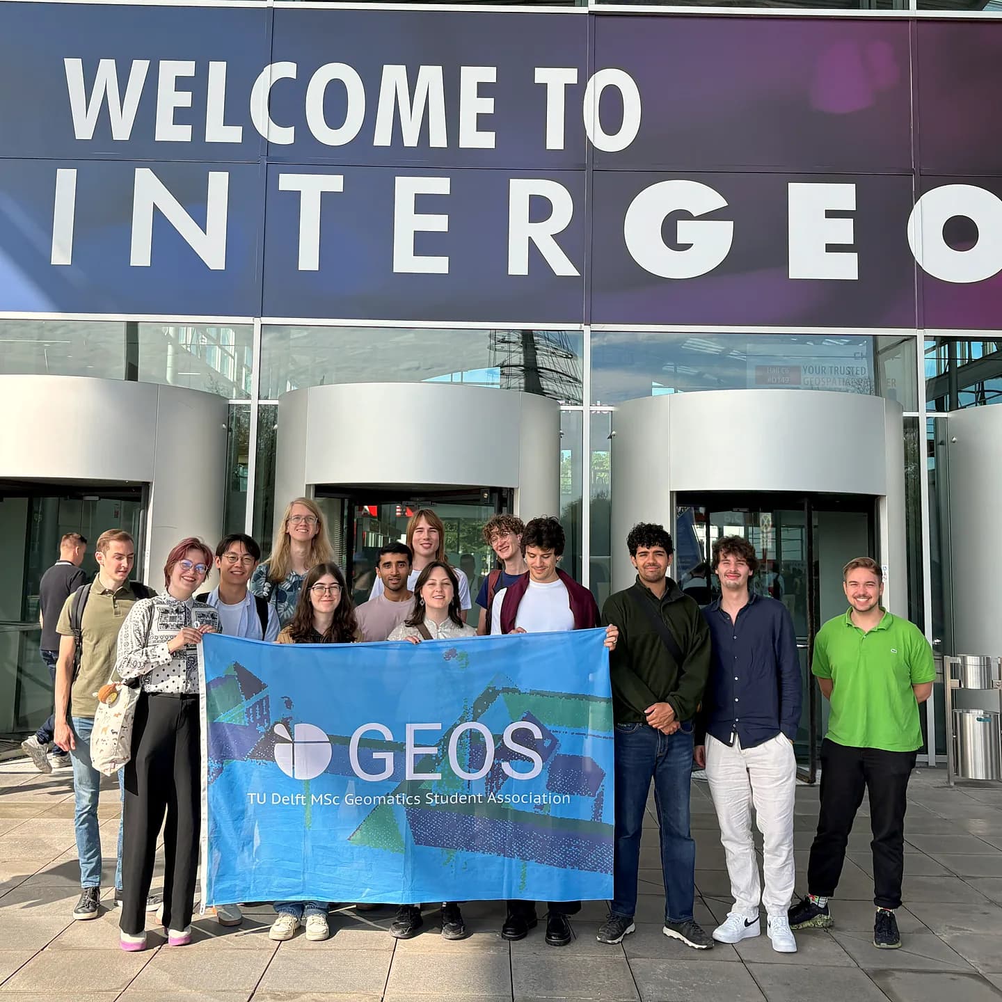 GEOS members holding the GEOS banner at the entrance of INTERGEO in Munich